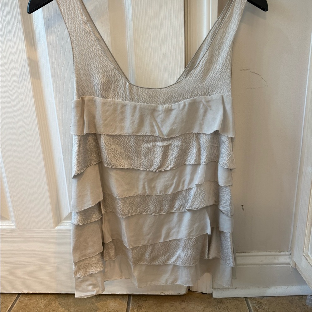Women’s silver sleeveless top.